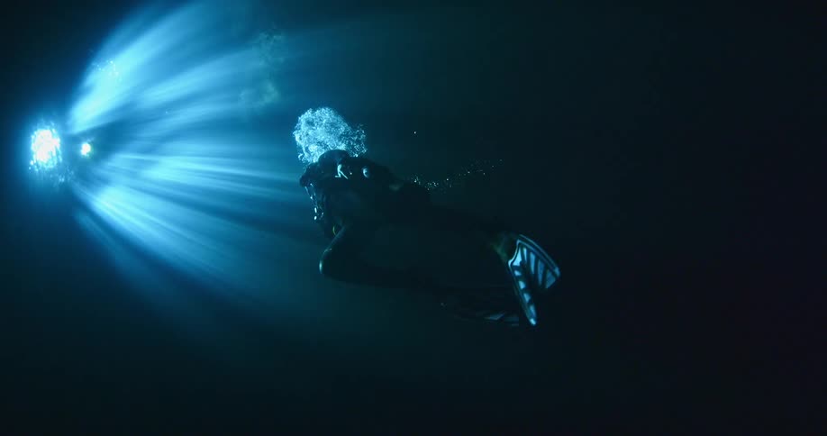 A scuba diver is ascending towards the surface