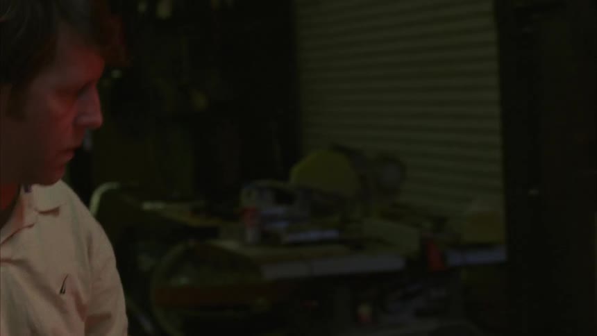 A man takes a glowing object out of a hot oven