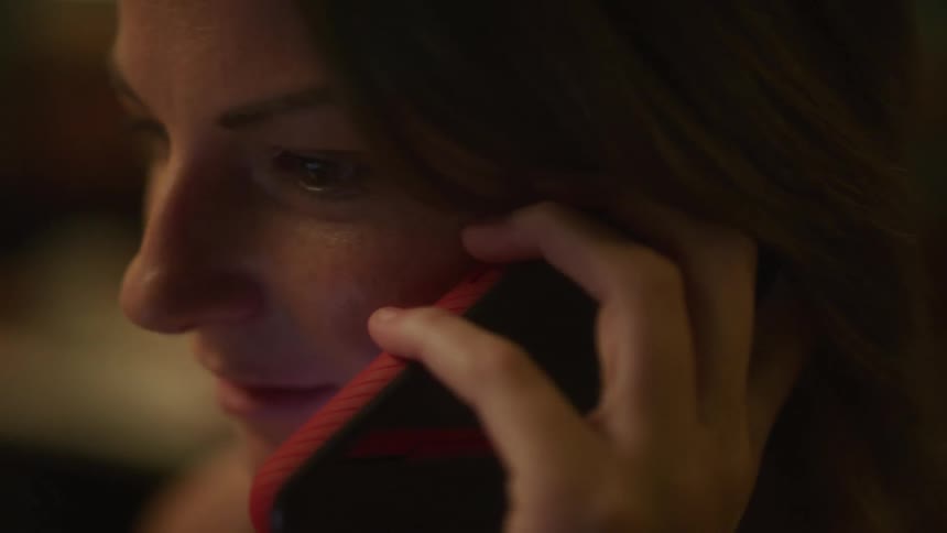 A woman is talking on her cell phone