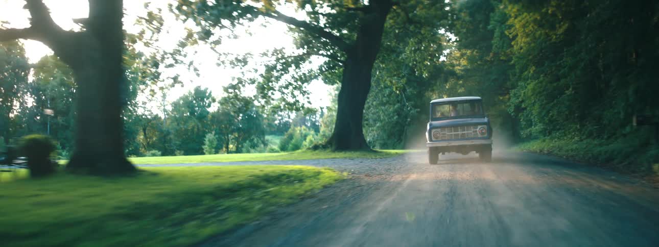 A van drives down the rural road