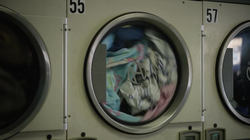 Clothes spinning in a dryer at a laundromat