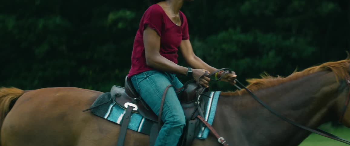 A woman is riding a horse outdoors in spring