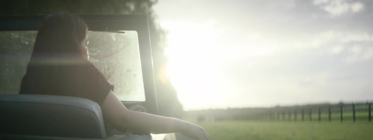 A view of a woman riding in a car
