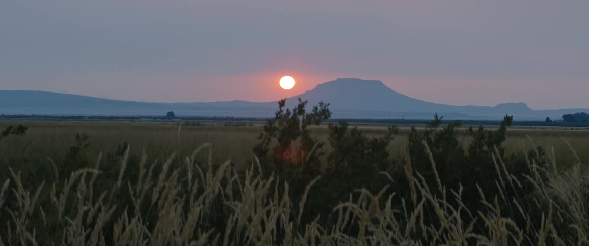 A view of a rural landscape is displayed at dusk