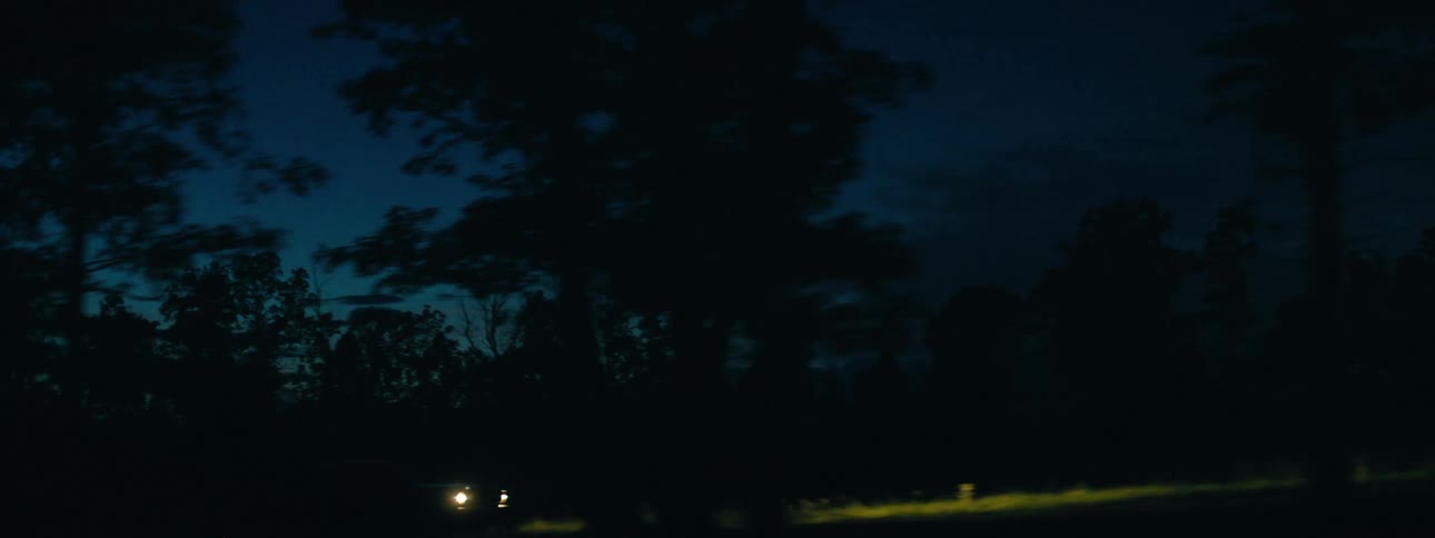 A car driving down a road at night