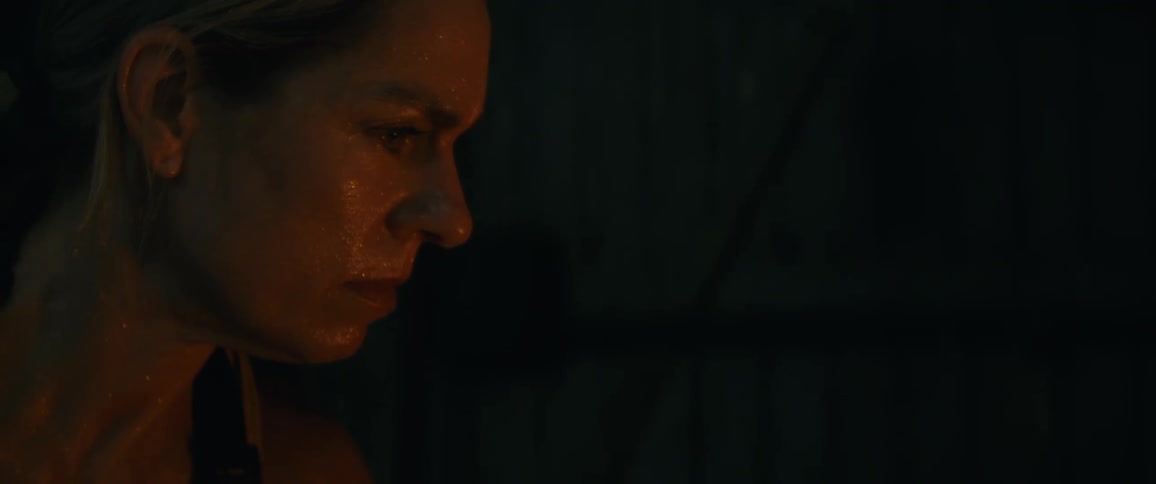 A woman in a room with a door in the background