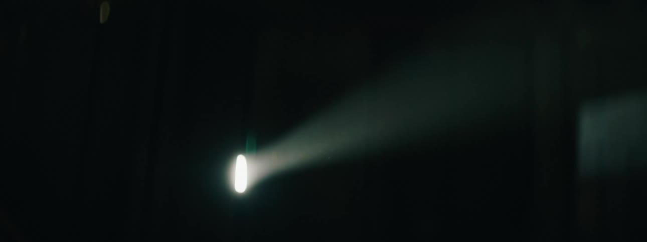 A beam of light shining through darkness