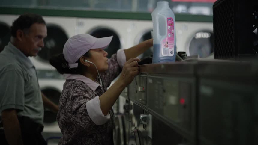 People are doing laundry in a laundromat