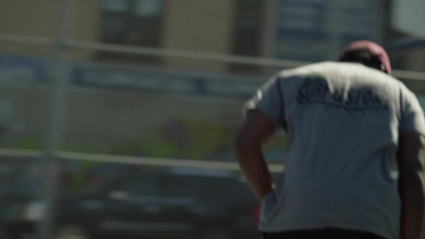 A man in a red hat skateboards