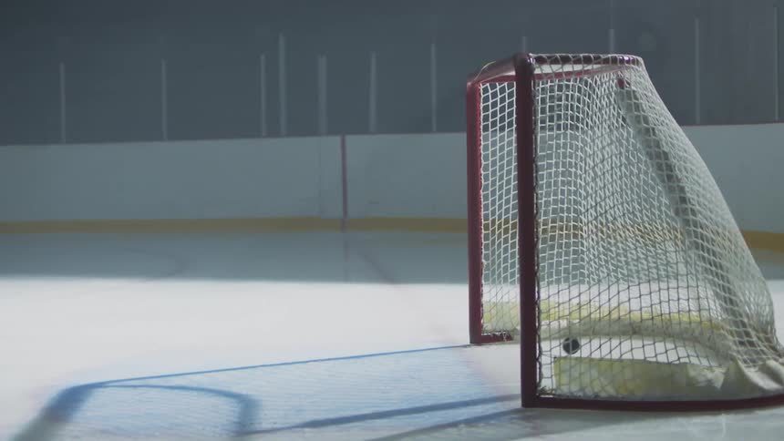 A puck entering a goal post