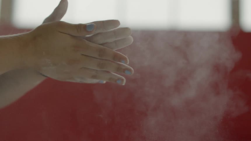 Person beating their dusty hands together