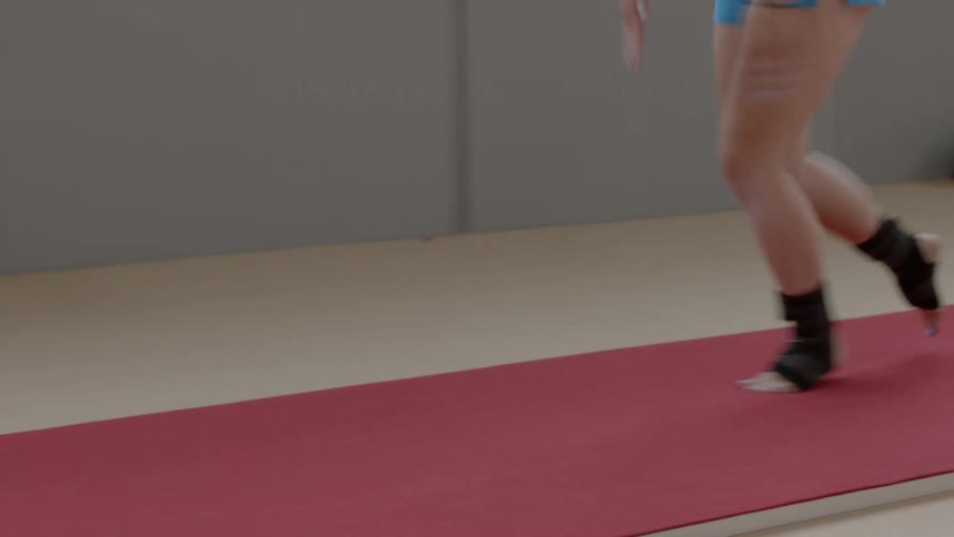 A gymnast sprints across the floor