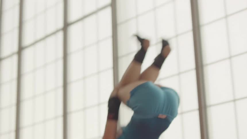 A gymnast flips in the air