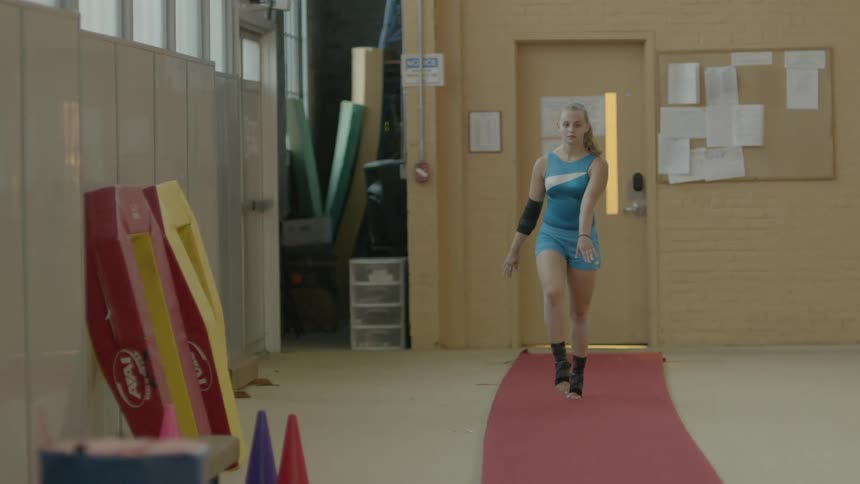 A young girl doing gymnastics