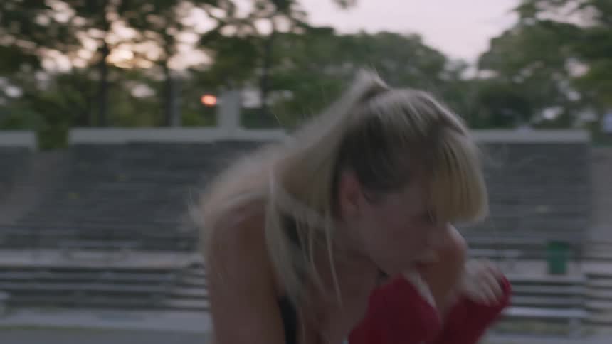A woman practices sparring outside