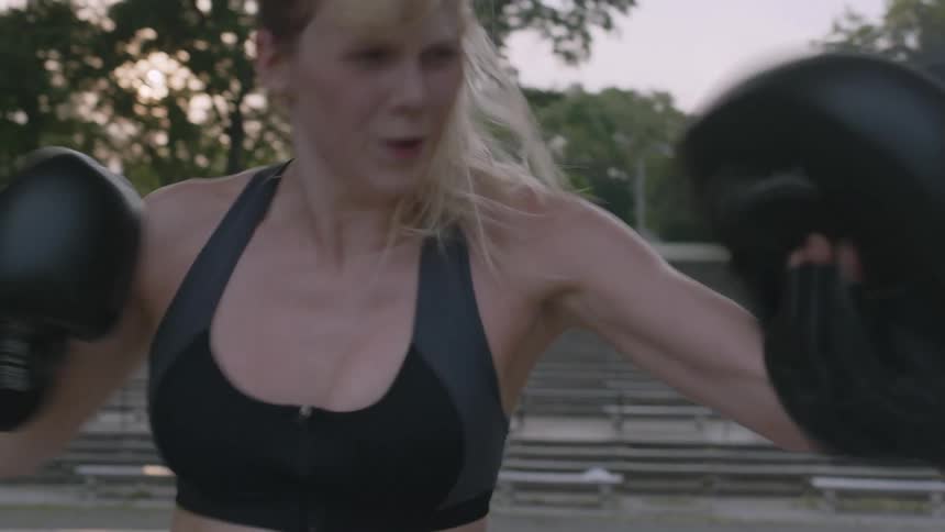 Woman practicing boxing with another person