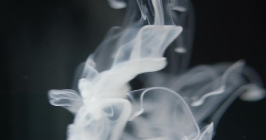 Dyed liquid descends into clear liquid