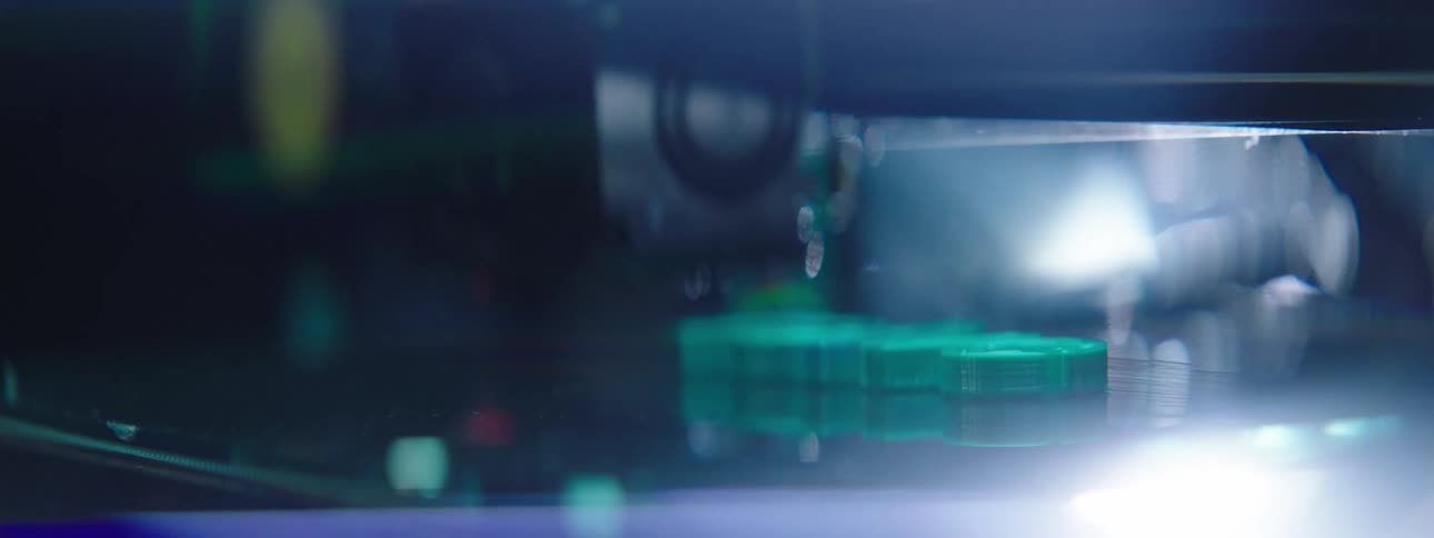 A laser machine etches a piece of glass