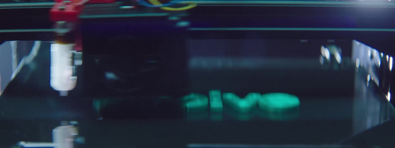 3d printer forms word composed of several neon colored letters
