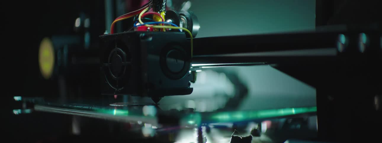 A laser machine etches a large piece of glass
