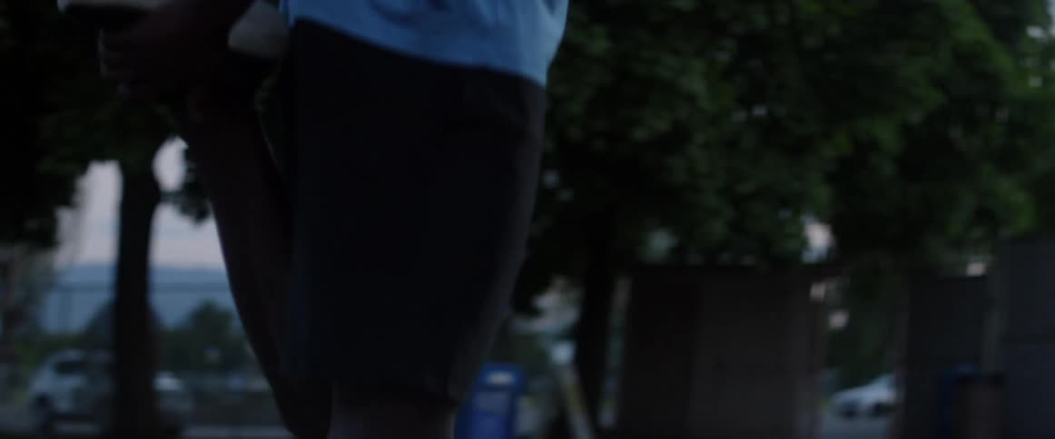 Person stretches their legs outside at night