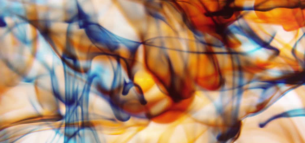 Orange and blue liquid swirling