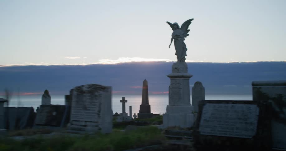 Headstones and monuments in a cemetery on the coast