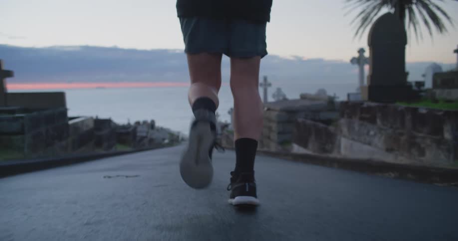 Man runs on a path next to the monuments at dawn