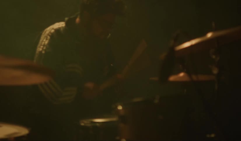 Man plays the drums and cymbals with drumsticks