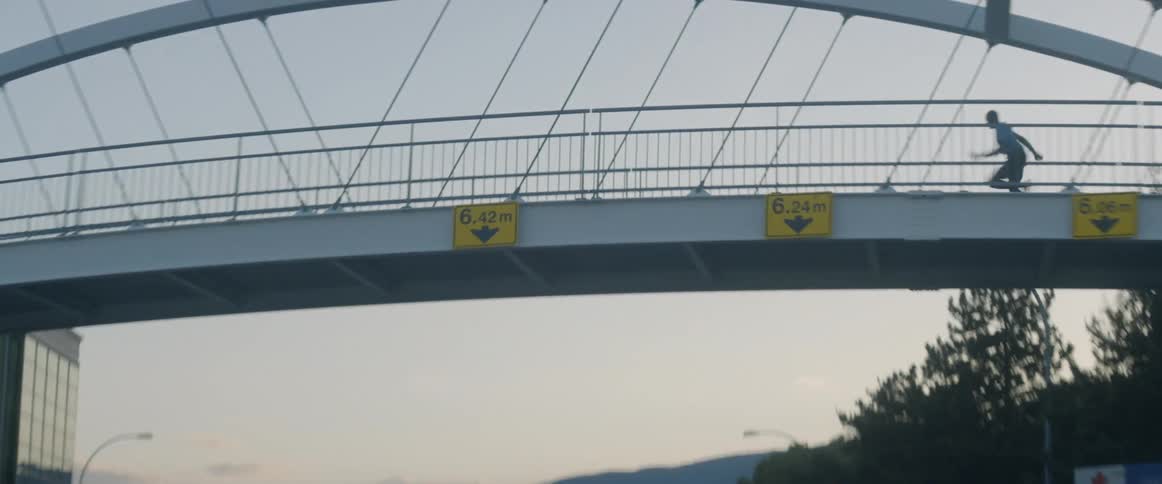 A man is running on the bridge over the road