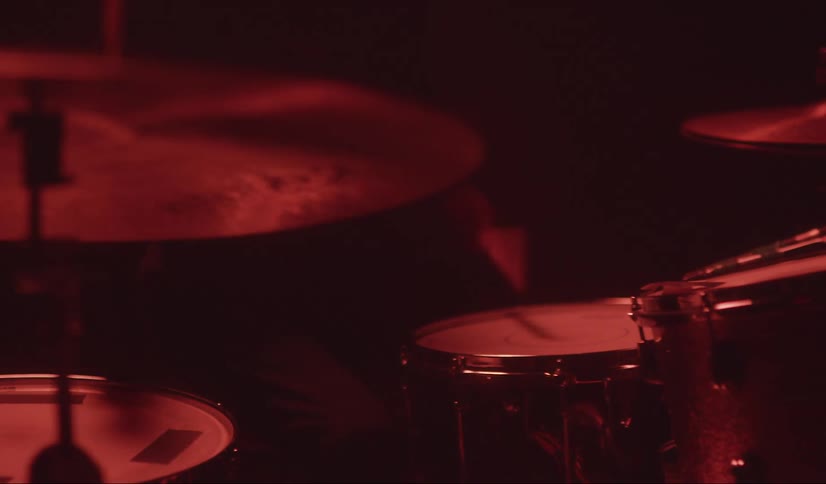 Drummer plays the drums with drumsticks