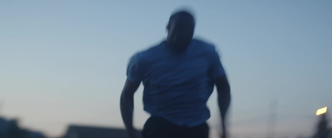 A man races off on the track at dawn