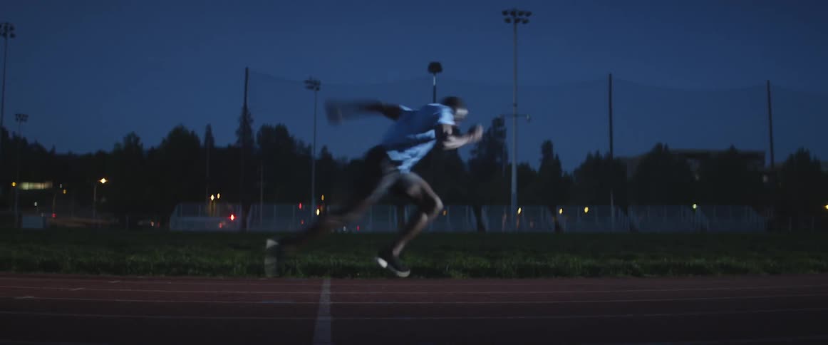 Person sprinting outside at night