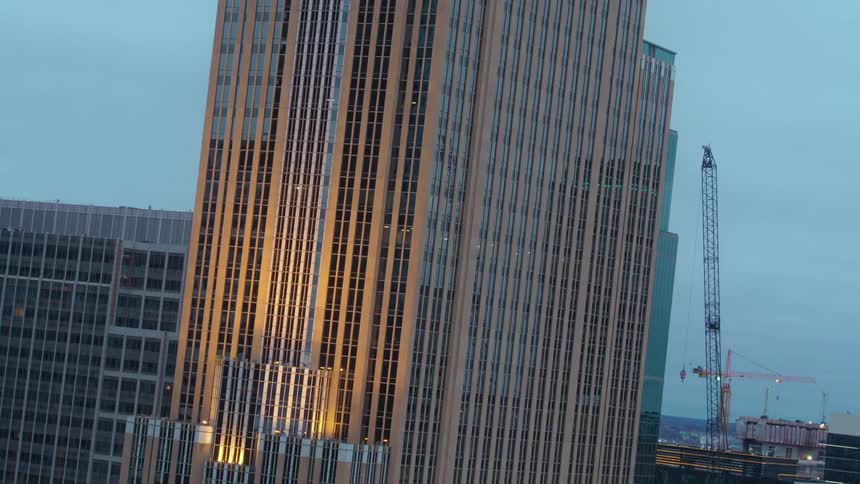 The tall building is in the middle of the city
