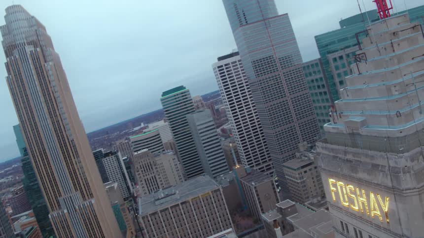 Skyscraper with illuminated text in the city with other skyscrapers