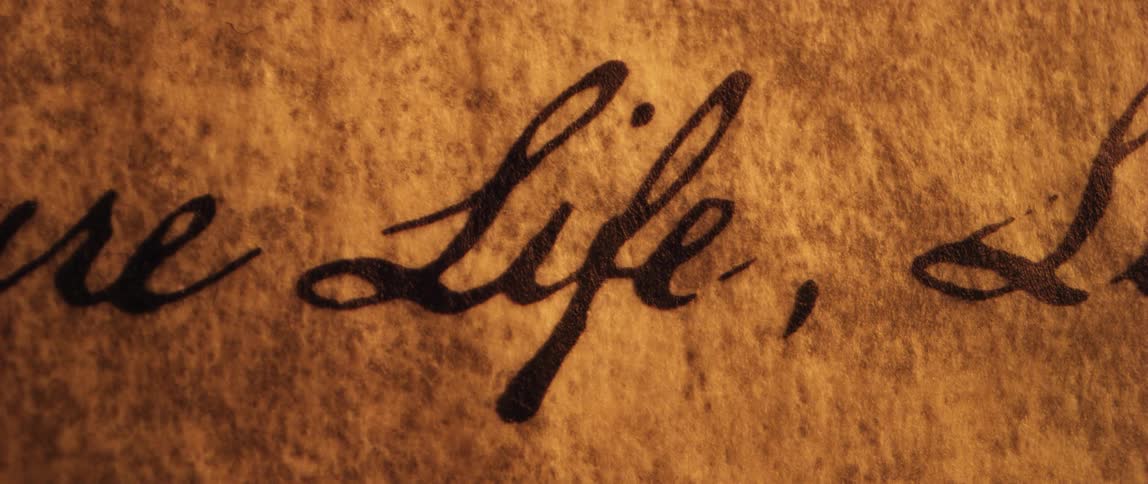 Light brightens and dims on calligraphy words on parchment