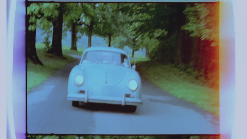A sports car moves down a road