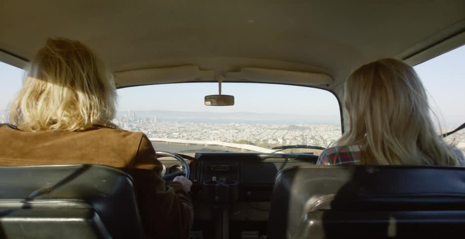 A man and woman ride in a vehicle