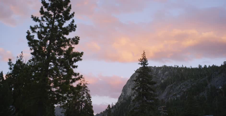 Clouds roll overhead of hills and trees