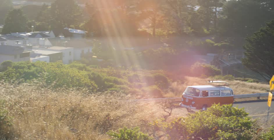 Van drives through the country on a sunny day