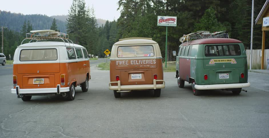 Three vans parked in a lot in the country