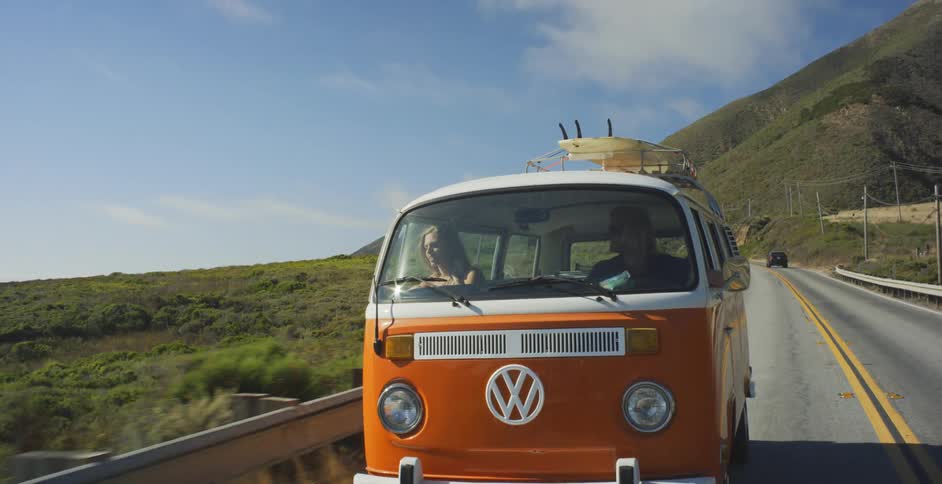 Man and woman travel in a volkswagen bus