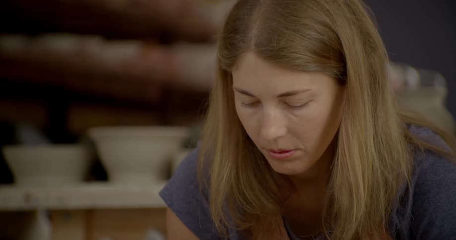 A blonde woman in a blue shirt