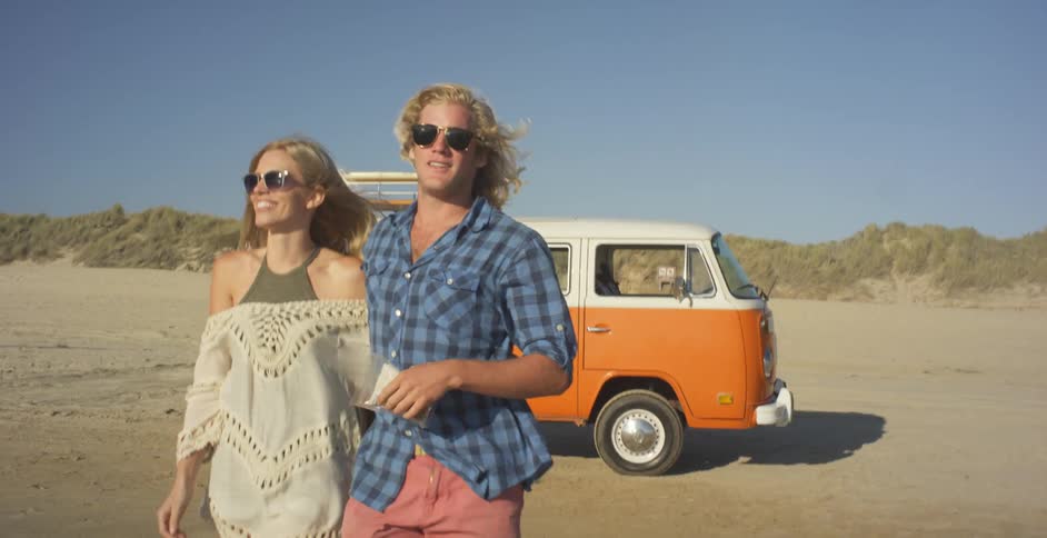 A couple walk together on the beach