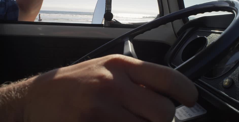 A man drives a vehicle on a beach