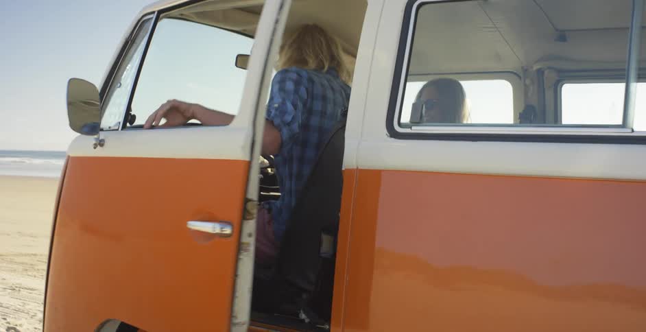 Man and woman riding and stopping in van