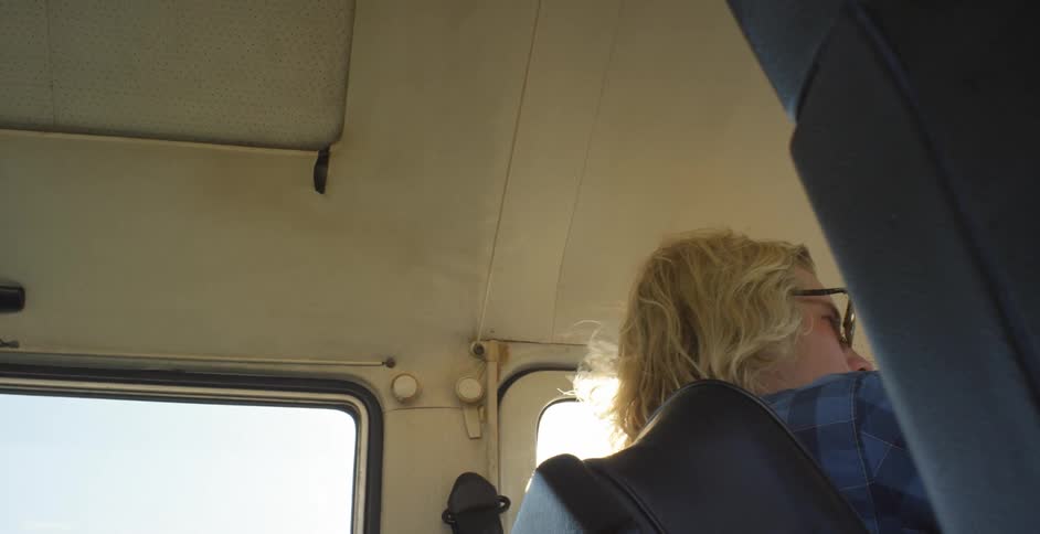 Sun shines through the driver side window of a traveling van