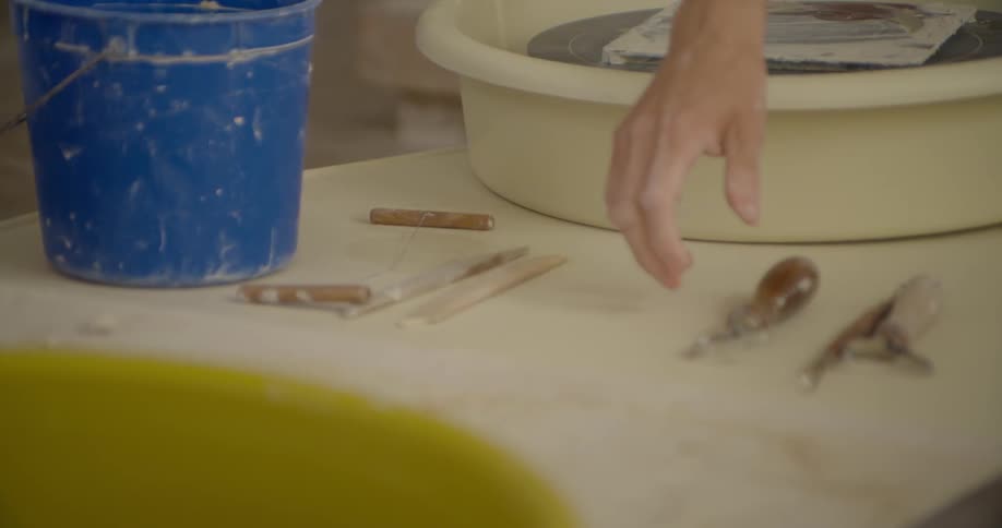 A person places some tools on a table