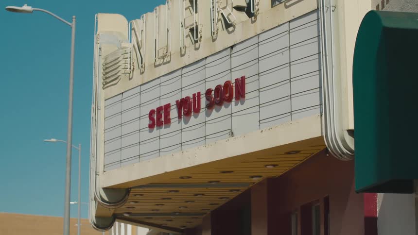 A movie theater leaves a message on its marquee for customers