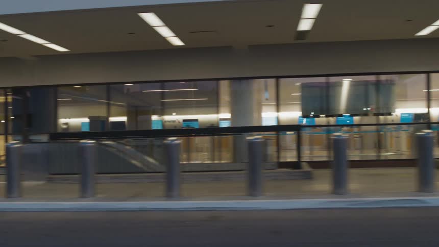 An empty bus station is displayed during the day